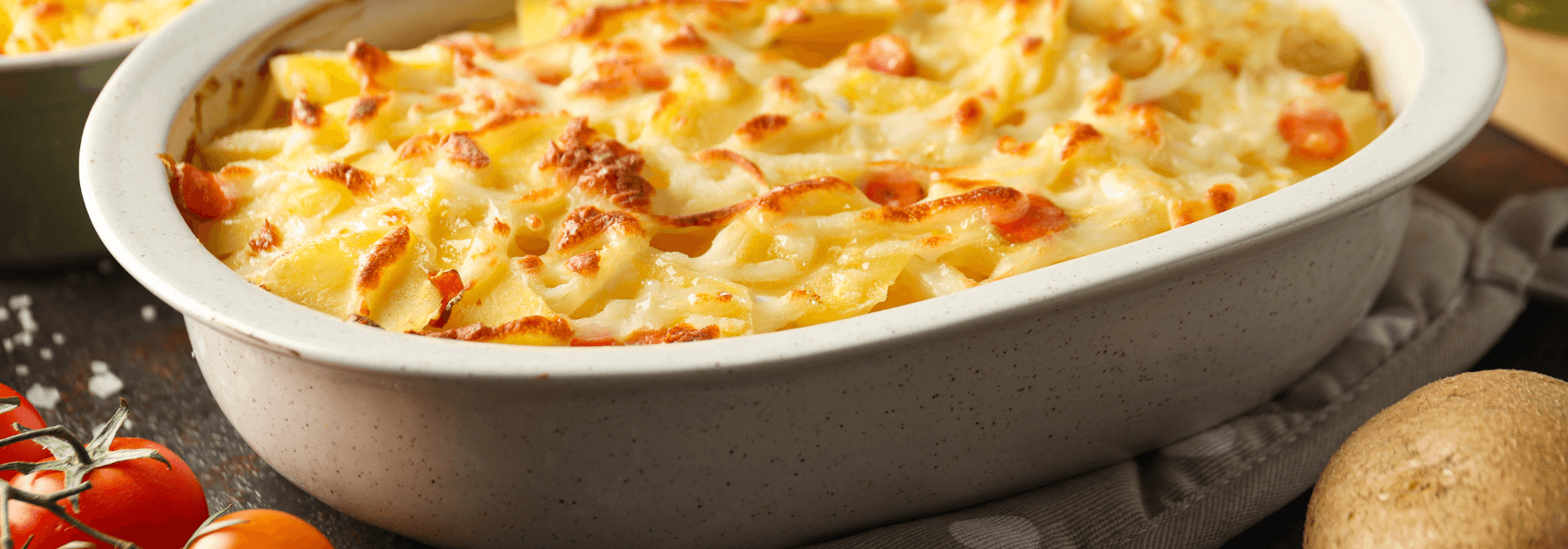 Freshly baked ricotta ravioli casserole in a glass dish, golden brown and cheesy.